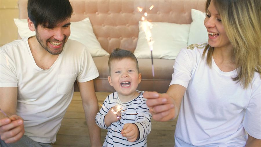Parents laughing with their toddler at home