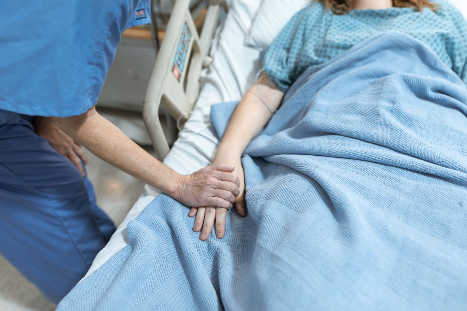 Nurse holding a patient’s hand, the kind of care a dialysis cruise team provides