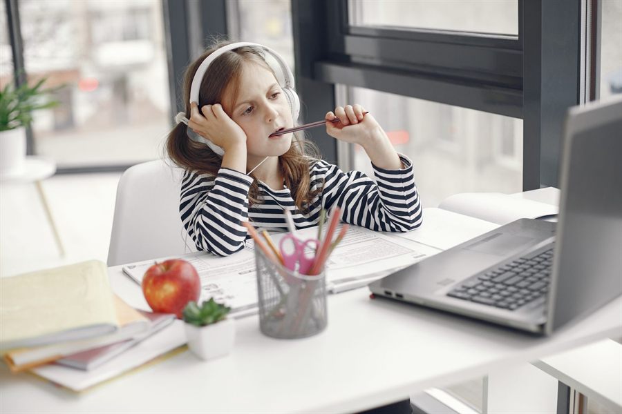 Girl wearing headphones at a desk