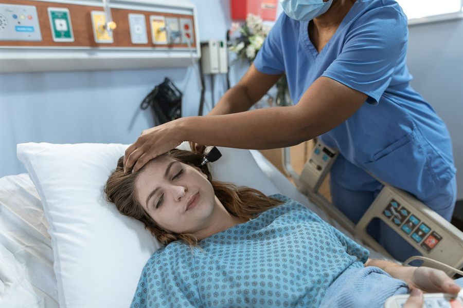 Nurse comforting a patient resting in bed