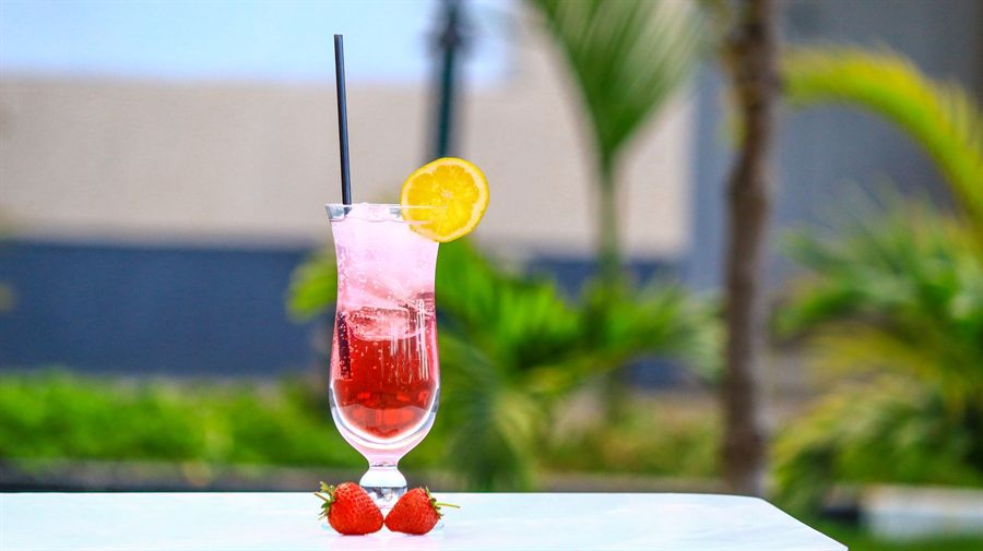 Pink alcohol-free drink with a strawberry and orange slice